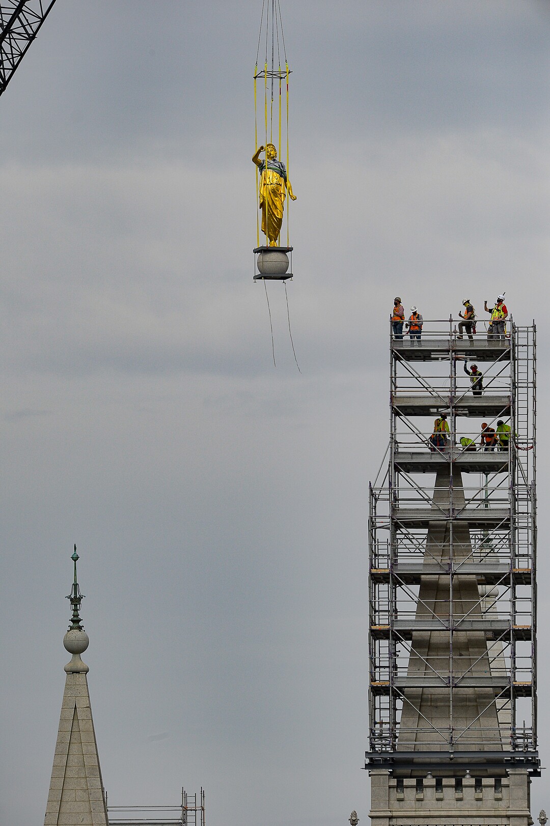 (Francisco Kjolseth  |  The Salt Lake Tribune) Crews work to remove the Angel Moroni statue atop the Salt Lake Temple of The Church of Jesus Christ of Latter-day Saints on Monday, May 18, 2020. The temple closed in December for seismic upgrades and sustained minor damager during the March 18, 2020, magnitude 5.7 earthquake when the trumpet held by the angel fell off and several smaller spire stones were displaced.