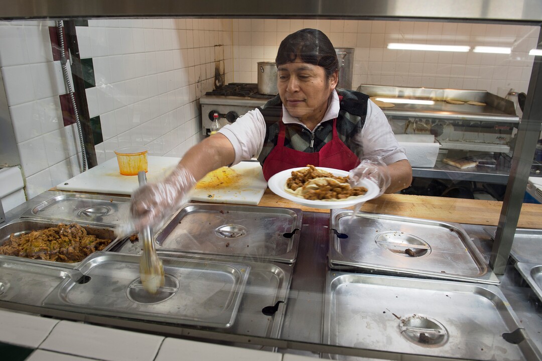 (Scott Sommerdorf   |  The Salt Lake Tribune)   Lucia Flores prepares a dish of tacos at Anaya's Market, which has a taqueria in back), in Park City.