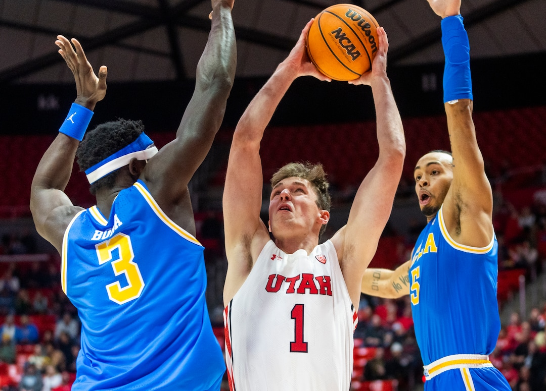 (Rick Egan | The Salt Lake Tribune) Utah Utes forward Ben Carlson (1) shoots as UCLA Bruins forward Adem Bona (3) and UCLA Bruins guard Amari Bailey (5) defend, in PAC-12 basketball action between Utah Utes and UCLA Bruins, at the Jon M. Huntsman Center, Thursday, February. 23, 2022.
