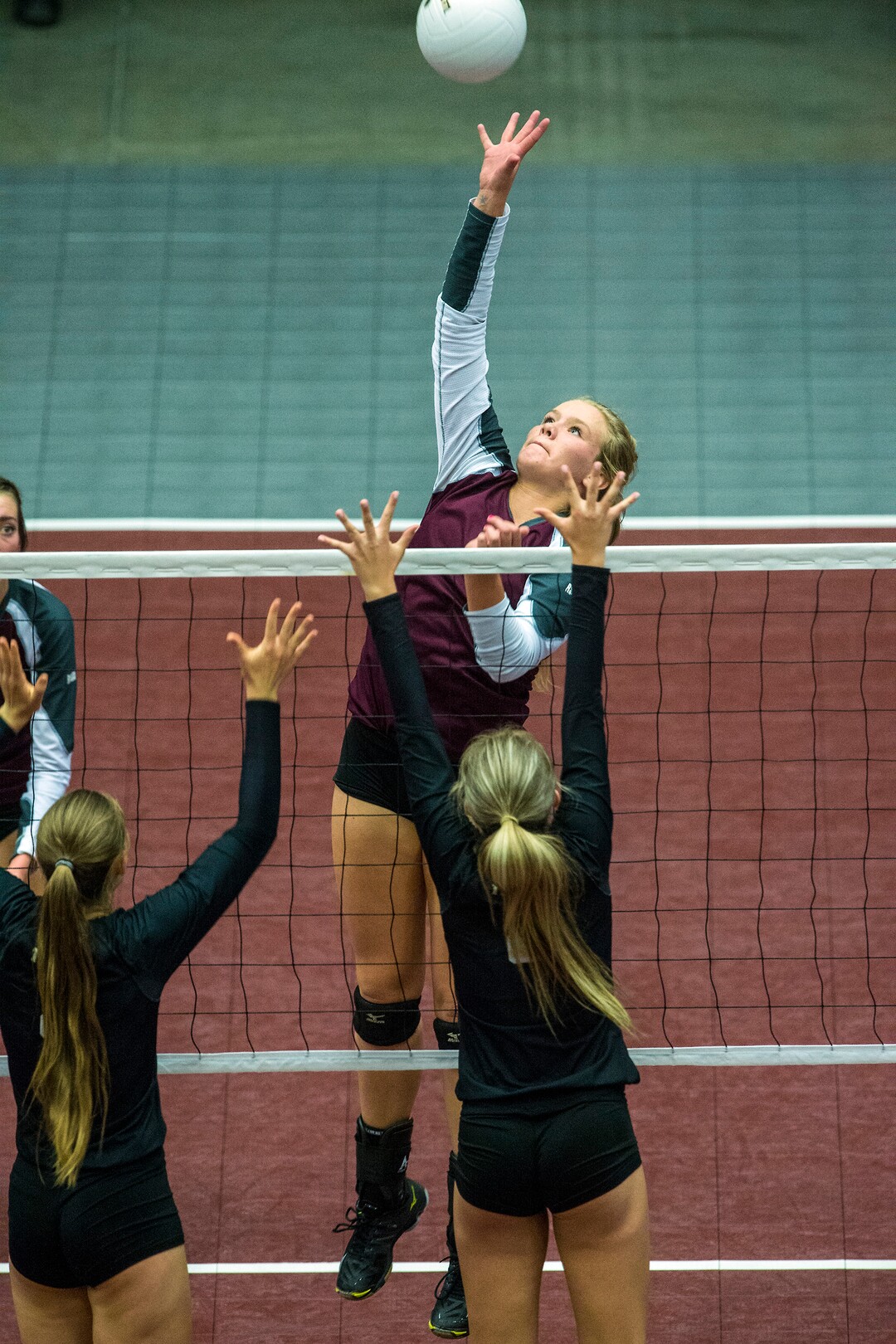 Chris Detrick  |  The Salt Lake TribuneMorgan's Marcie Stapley (9) spikes the ball past Desert Hills' Jessica Harris (8) and Desert Hills' Hailee Harmer (2) during the Class 3A state volleyball championship match Thursday October 27, 2016. 