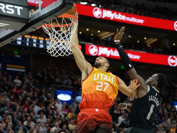 (Francisco Kjolseth  |  The Salt Lake Tribune)  Utah Jazz center Rudy Gobert (27) dunks the ball as Detroit Pistons guard Reggie Jackson (1) pressure Gobert during the second half of an NBA basketball game Monday, Jan. 14, 2019, in Salt Lake City.
