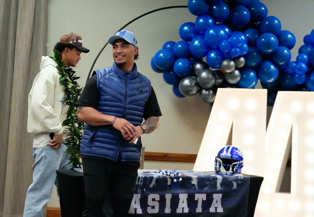 (Francisco Kjolseth | The Salt Lake Tribune) Ephraim Asiata, a top 15 player in Utah, joins his father Matt Asiata, a former NFL running back, and University of Utah player as he introduces his son’s choice of playing for BYU while surrounded by friends and family in West Jordan on Tuesday, Dec. 19, 2023.