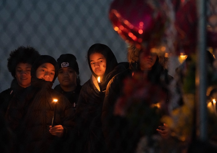 (Francisco Kjolseth | The Salt Lake Tribune) More that a hundred people gather at the candlelight vigil of Hunter High football players Paul Tahi , 15, Tivani Lopati, 14, and Ephraim Asiata, 15, on Friday, Jan 14, 2022, in West Valley City, near Hunter High School along 1400 South at Mountain View Corridor. Paul Tahi and Tivani Lopati were killed in a shooting, while Ephraim Asiata remains in critical condition.