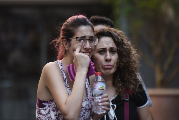 (Giannis Papanikos | The Associated Press) People flee from the scene after a white van jumped the sidewalk in the historic Las Ramblas district of Barcelona, Spain, crashing into a summer crowd of residents and tourists Thursday, Aug. 17, 2017.   According to witnesses the white van swerved from side to side as it plowed into tourists and residents.
