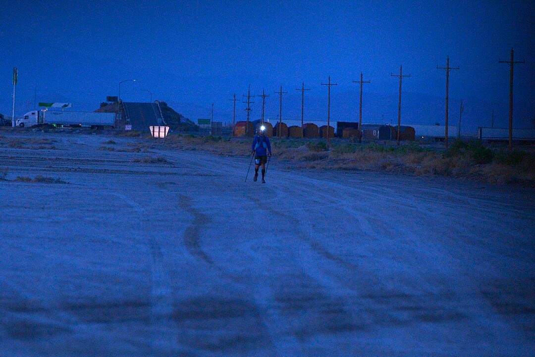 (Scott Sommerdorf | The Salt Lake Tribune)Eighth place finisher Alex Doolan with his headlamp lit, approaches Aid Station 14 at the Salt Flats 100 Endurance Run, Saturday, May 5, 2018.