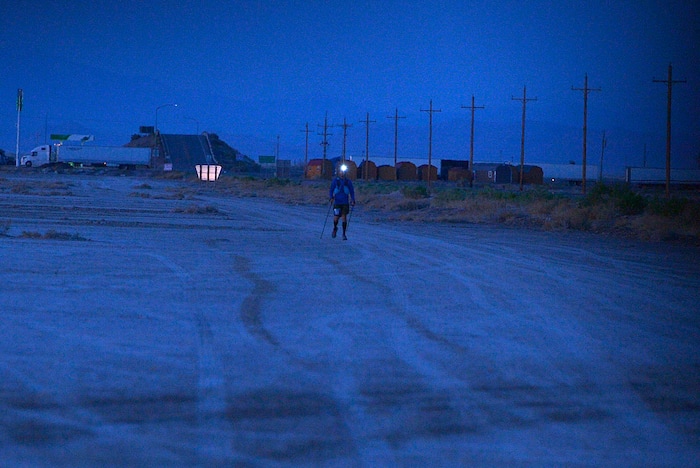 (Scott Sommerdorf | The Salt Lake Tribune)
Eighth place finisher Alex Doolan with his headlamp lit, approaches Aid Station 14 at the Salt Flats 100 Endurance Run, Saturday, May 5, 2018.
