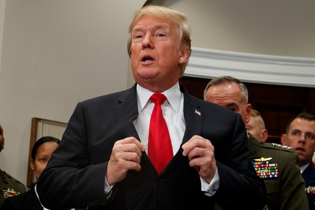 President Donald Trump adjusts his suit jacket after signing the National Defense Authorization Act for Fiscal Year 2018 bill, in the Roosevelt Room of the White House, Tuesday, Dec. 12, 2017, in Washington. Plowing into the sexual harassment debate in a big way, Trump laced into Sen. Kirsten Gillibrand, tweeting that the New York Democrat would come to his office "begging" for campaign contributions and "do anything" to get them. Democrats accused the president of making crude insinuations. (AP Photo/Evan Vucci)