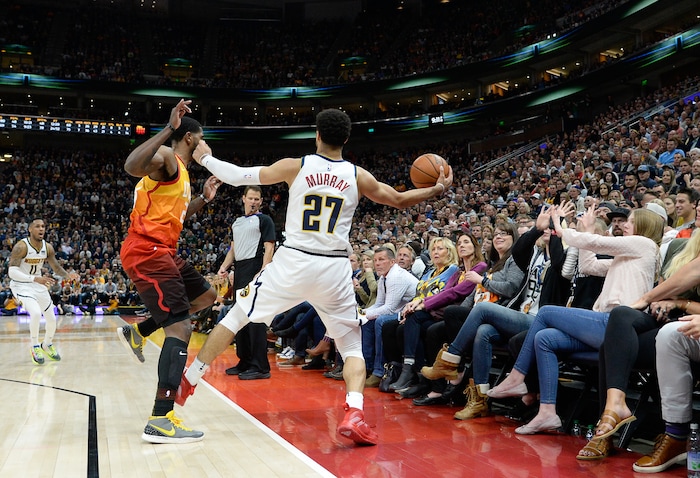 (Francisco Kjolseth  |  The Salt Lake Tribune)  Utah Jazz forward Royce O'Neale (23) chases a ball down with Denver Nuggets guard Jamal Murray (27) ending up in the stands as the Utah Jazz host the Denver Nuggets in their NBA game at Vivint Smart Home Arena Tuesday, April 9, 2019, in Salt Lake City.
