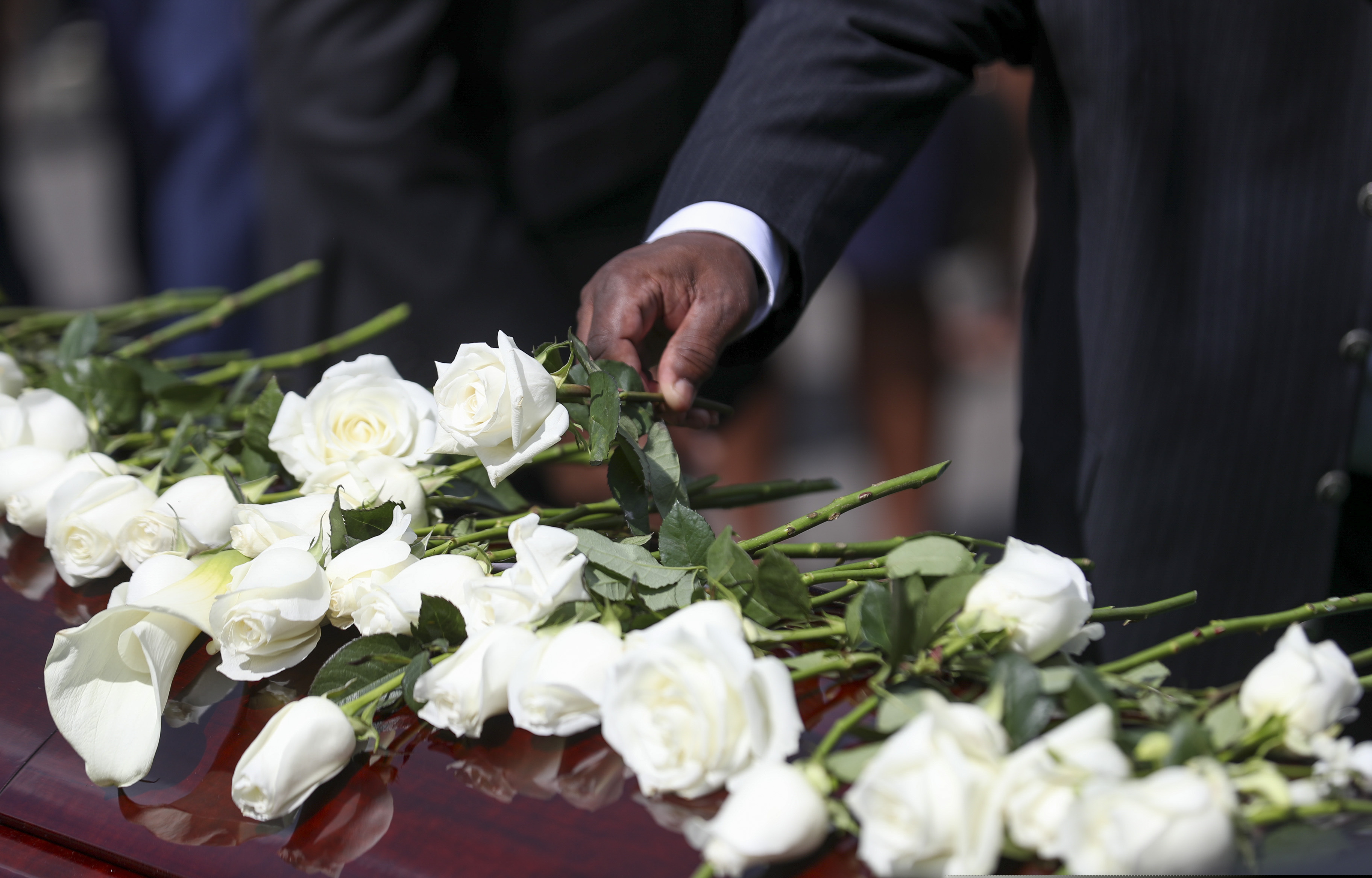 Family members place flowers on the casket of Rep. John Lewis during the burial service at South-View Cemetery in Atlanta Thursday, July 30, 2020. (Alyssa Pointer/Atlanta Journal-Constitution via AP, Pool)