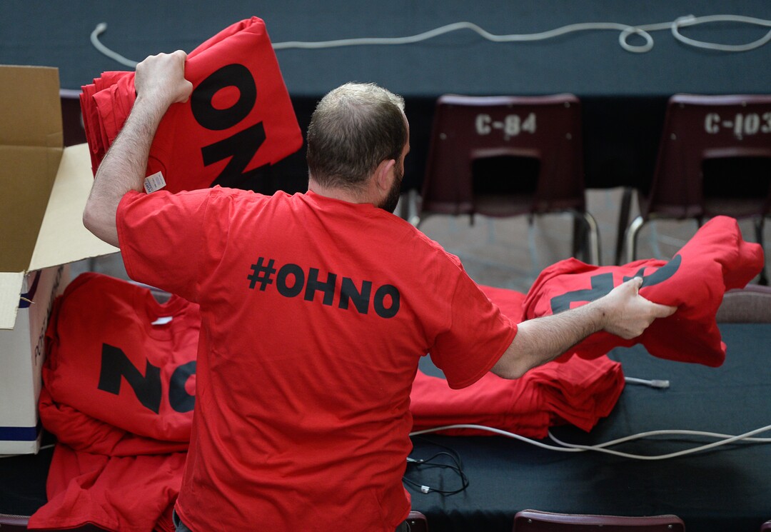 (Francisco Kjolseth  |  The Salt Lake Tribune) Teddy Hodges of Herriman, puts out shirts expressing opposition to the proposed Olympia Hills development prior to Salt Lake County Council taking the first of two votes on Tuesday, Feb. 25, 2020, on a set of zoning changes for the controversial new housing and commercial development proposed on unincorporated county land on Herriman's western border. The County Council approved the zoning changes 6-to-3, as residents from Herriman, Bluffdale and Riverton who oppose the project turned out for the hearing to voice their concerns.