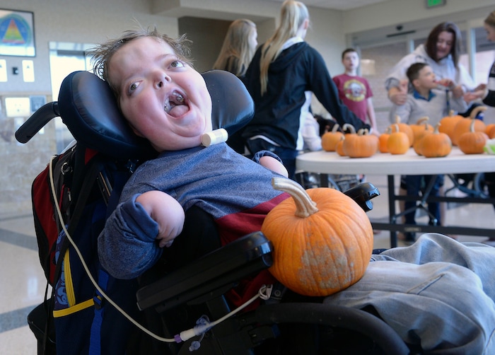 (Al Hartmann | The Salt Lake Tribune)
Tyler Barton, 10, a student at Kauri Sue Hamilton School in Riverton laughs with delight after picking a pumpkin grown by inmates in the Green Thumb Nursery program at Utah State Prison. Thousands of pumpkins were harvested this season for donation to local children with significant disabilities.