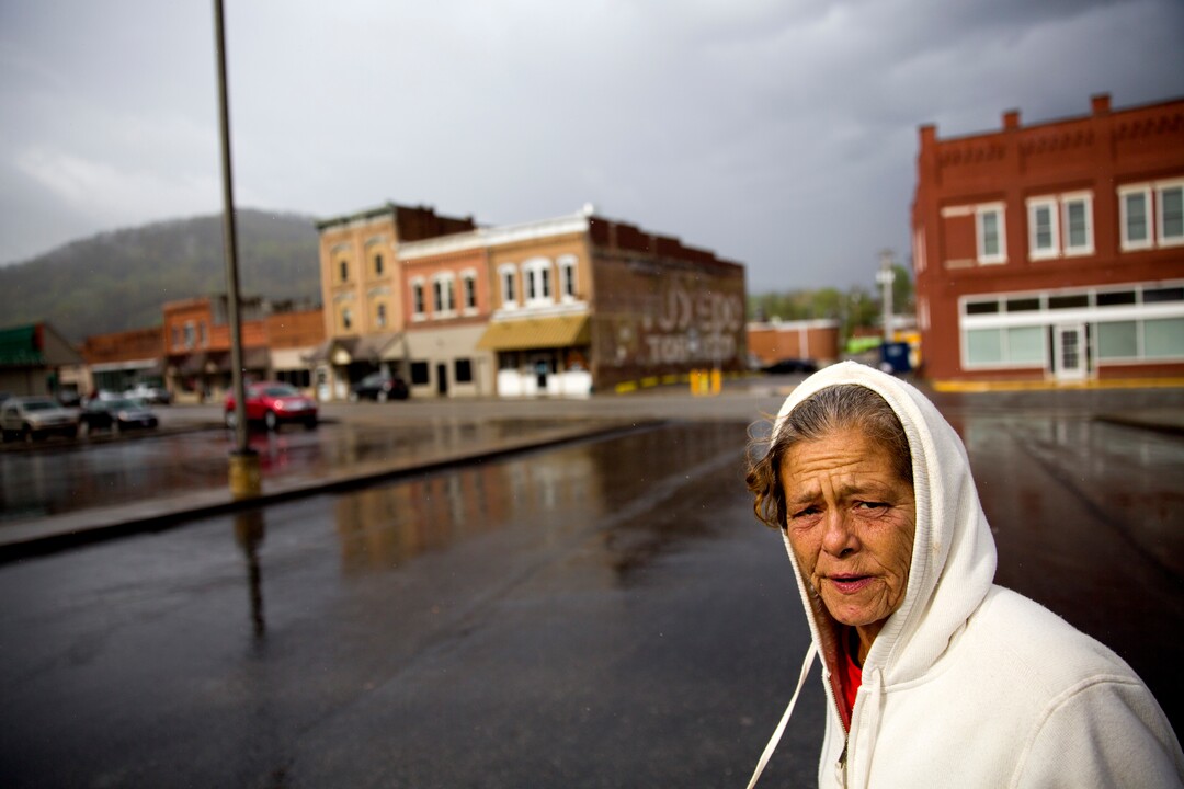 Tammy Perry, 53, walks down a street in LaFollette, Tenn., where she is currently staying with an older man after getting out of jail, Monday, April 23, 2018. Perry still struggles with drug addiction and says she exchanges sex for drugs or money to support her addiction. Her daughter also struggles with addiction and both have been in jail at the same time. (AP Photo/David Goldman)