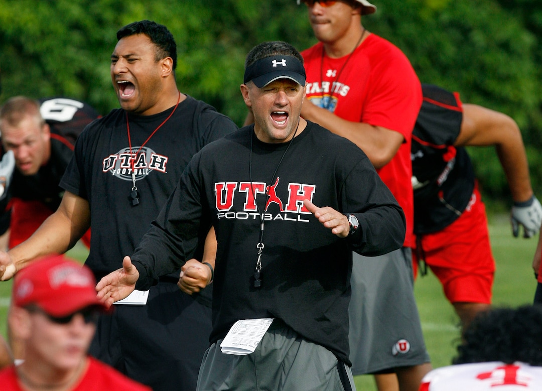 UTAH FOOTBALL Utah head coach Kyle Whittingham (center) and defensive coordinator Kalani Sitake (left) yell as they have the team break up into smaller units to begin drills, Thursday, 8/06/09.Scott Sommerdorf  / The Salt Lake Tribune
