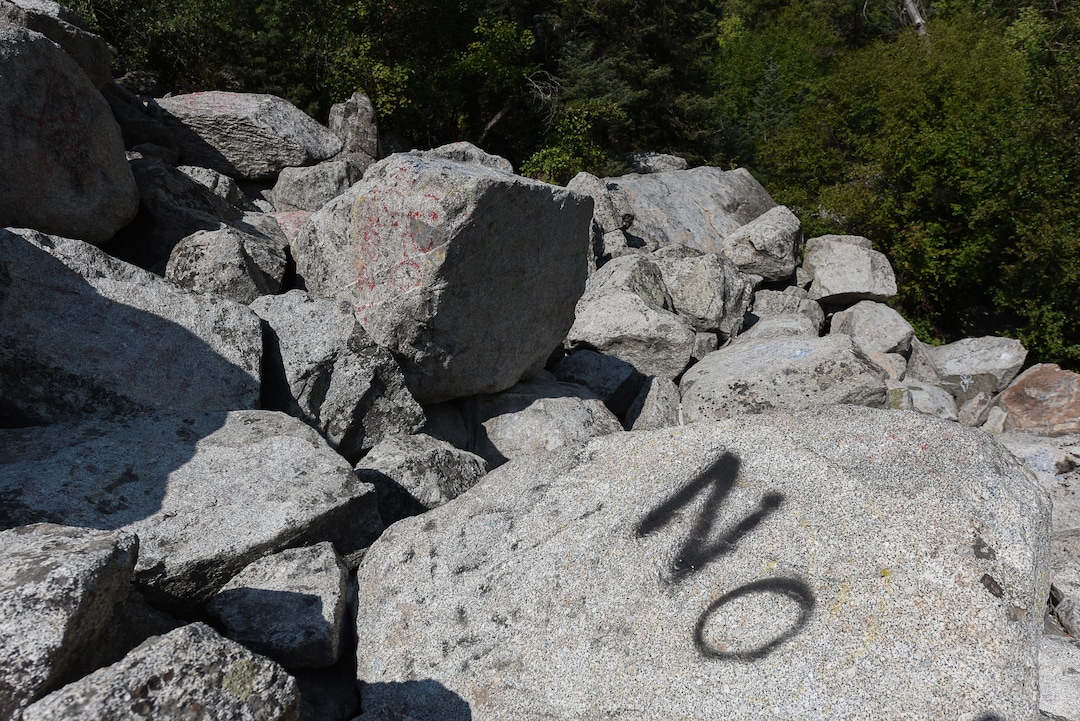 (Francisco Kjolseth  |  The Salt Lake Tribune)  Graffiti has proliferated in lower Little Cottonwood Canyon, where vandals, often wielding cans of fluorescent-colored spray paint, have covered granite faces, trees and structures. The vandalism is particularly apparent along the Temple Quarry Trail and the creek at the Moon Rock swimming hole and former pavilion site. Volunteers using donated equipment and solvents spend thousands of hours removing the paint from the rocks only to see graffiti return to the same faces or on rock nearby.
