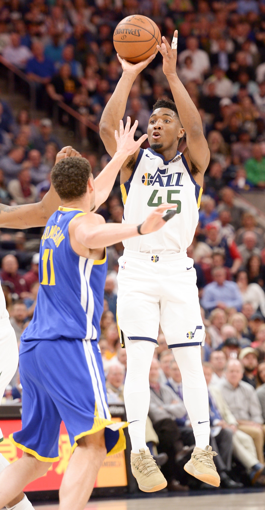 (Leah Hogsten  |  The Salt Lake Tribune)  Utah Jazz guard Donovan Mitchell (45) shoots past Golden State Warriors guard Klay Thompson (11).  The Utah Jazz lead the Golden State Warriors 62-33 during their game, Tuesday, April 10, 2018 at the Vivant Smart Home Arena. 