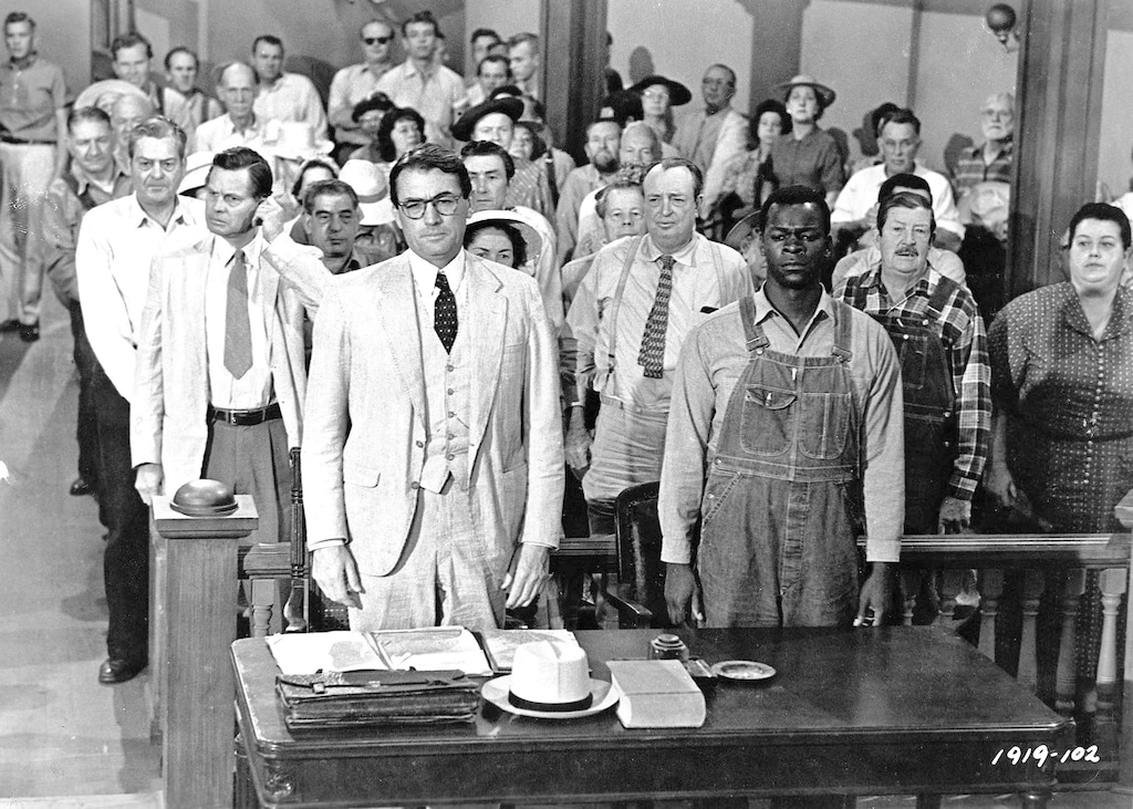 (Universal Studios Home Entertainment | AP) This picture provided by Universal Studios Home Entertainment shows actors Gregory Peck, foreground left, and Brock Peters, foreground right, in a scene from the 1962 film "To Kill a Mockingbird."