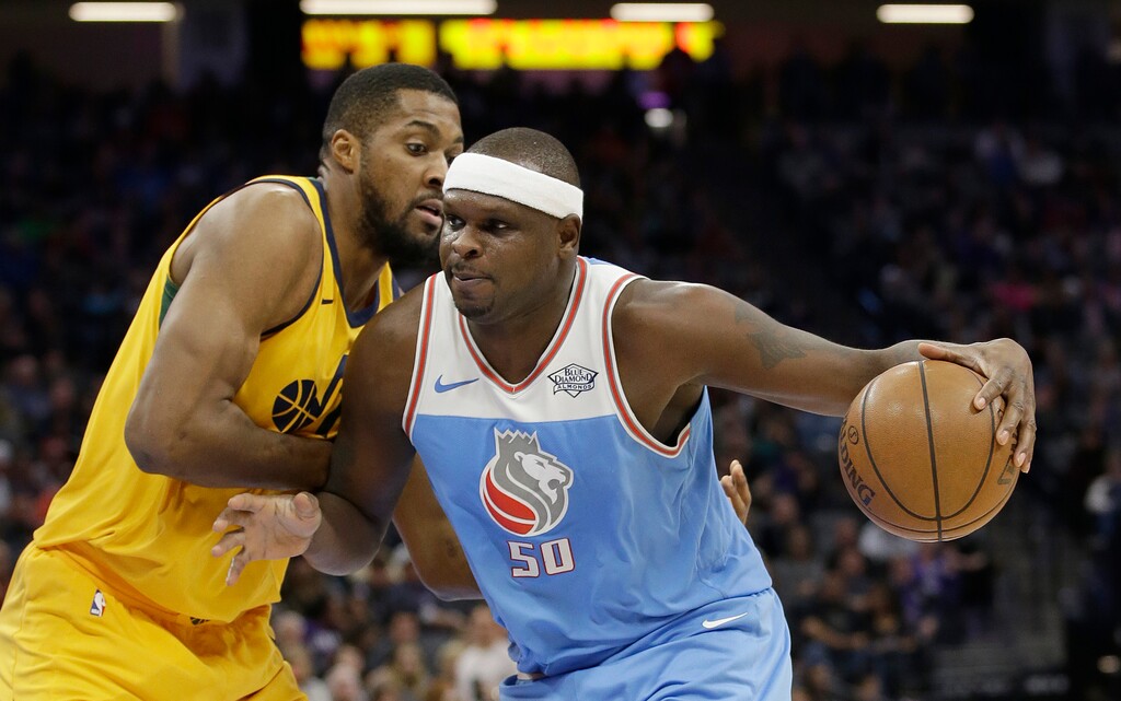 Sacramento Kings forward Zach Randolph. right, drives against Utah Jazz forward Derrick Favors during the first quarter of an NBA basketball game Saturday, March 3, 2018, in Sacramento, Calif. (AP Photo/Rich Pedroncelli)