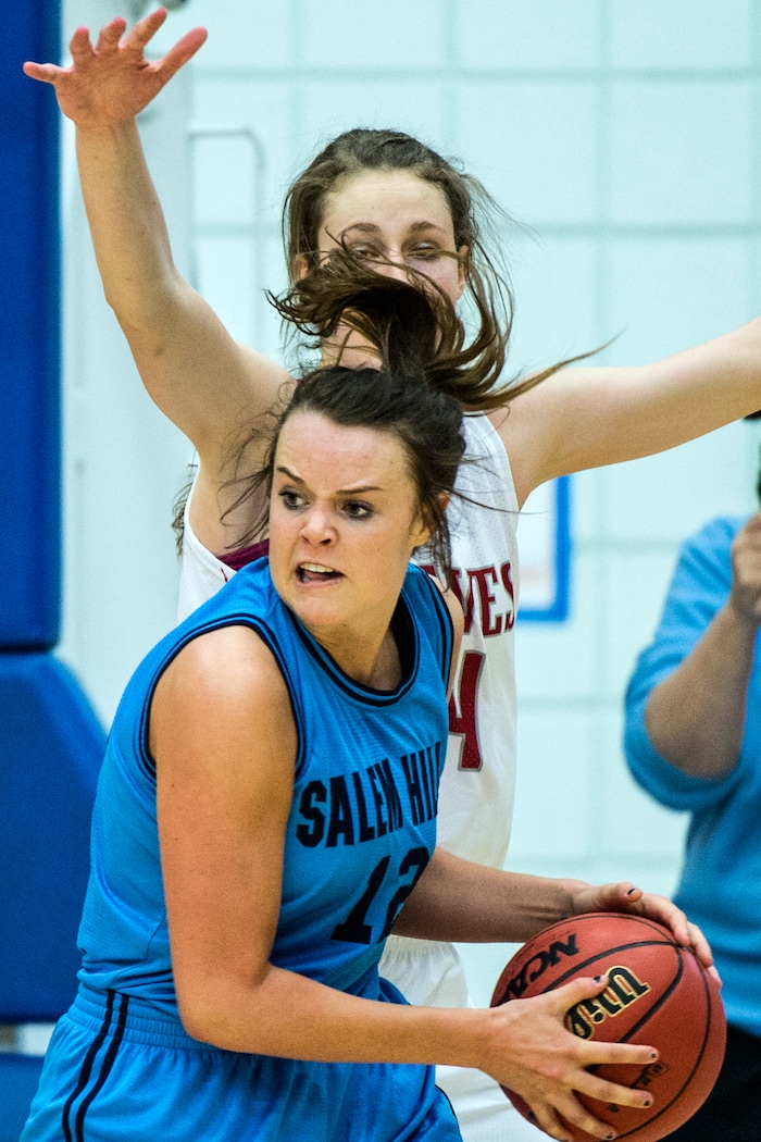 Chris Detrick  |  The Salt Lake TribuneSalem Hills's Lauren Gustin (12) runs around Bountiful's Kennedy Redding (24) during the 4A girls' basketball semifinals at Salt Lake Community College Friday February 26, 2016. Bountiful won the game 59-51.