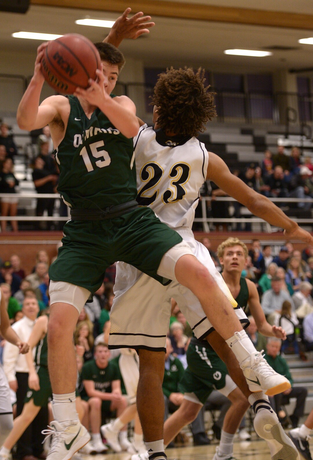 (Leah Hogsten  |  The Salt Lake Tribune) Olympus' Rylan Jones pulls down the rebound. Olympus High School defeated Highland High School 86-54 during their basketball game, Tuesday, February 6, 2018.