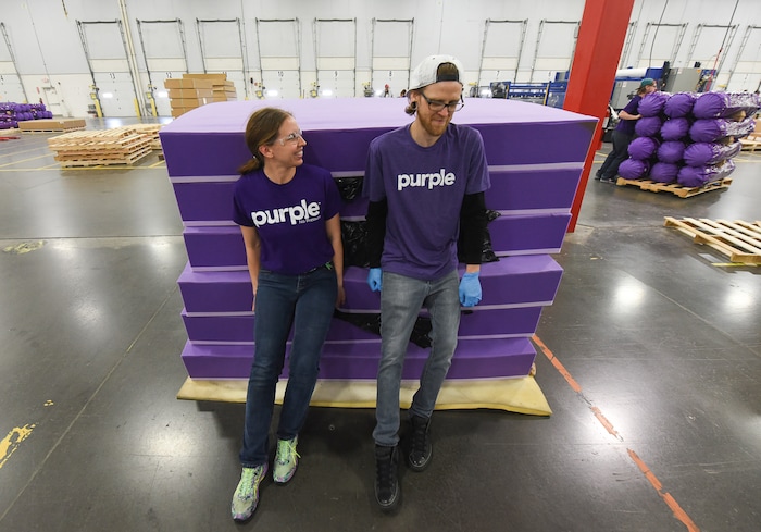 (Francisco Kjolseth | The Salt Lake Tribune)  Malia Spence and Jake Williams make room to unroll mattress cores made up of "individual responsive support coils" while working the core line at Purple, an Alpine based company that has developed tech to manufacture flexible mattresses at a plant in Grantsville.