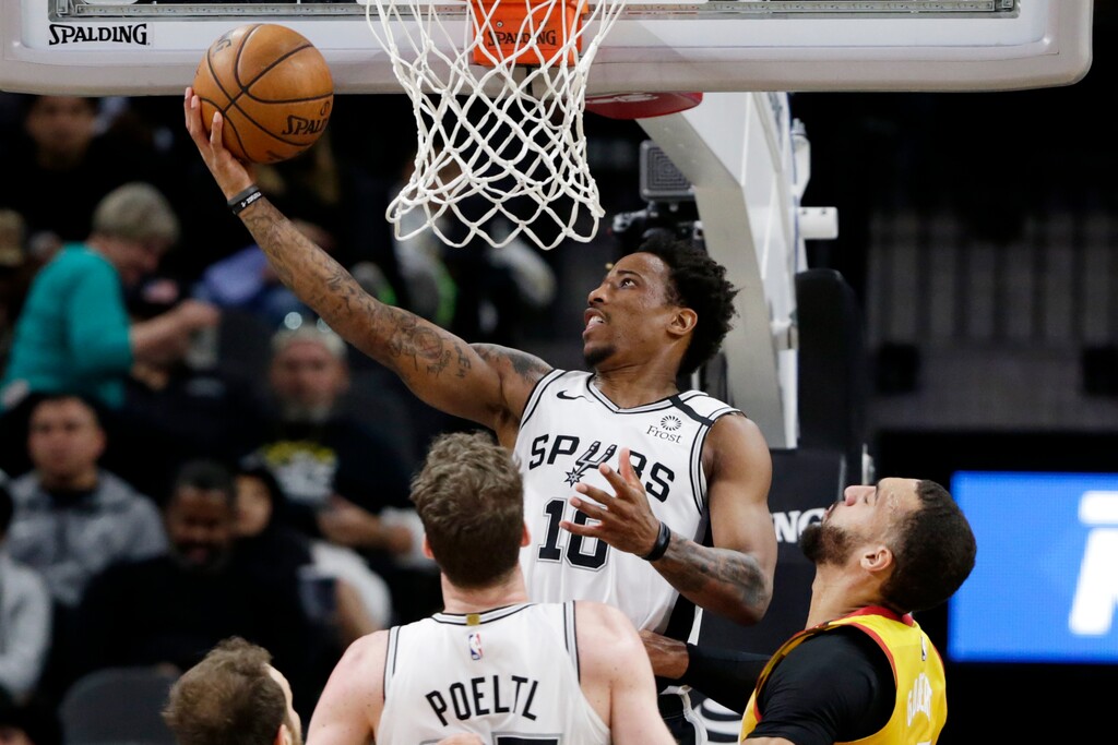 San Antonio Spurs forward DeMar DeRozan (10) scores over Utah Jazz center Rudy Gobert (27) during the first half of an NBA basketball game in San Antonio, Wednesday, Jan. 29, 2020. (AP Photo/Eric Gay)