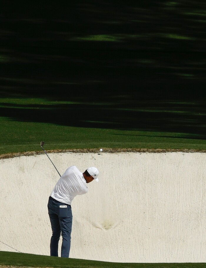 Tony Finau hits from a bunker on the eighth hole during the second round at the Masters golf tournament Friday, April 6, 2018, in Augusta, Ga. (AP Photo/Charlie Riedel)