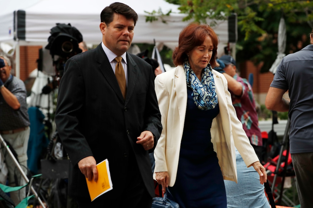 Paul Manafort's wife Kathleen Manafort, right, walks with Manafort spokesman Jason Maloni, to federal court for jury deliberations in the trial of the former Trump campaign chairman, in Alexandria, Va., Tuesday, Aug. 21, 2018. (AP Photo/Jacquelyn Martin)