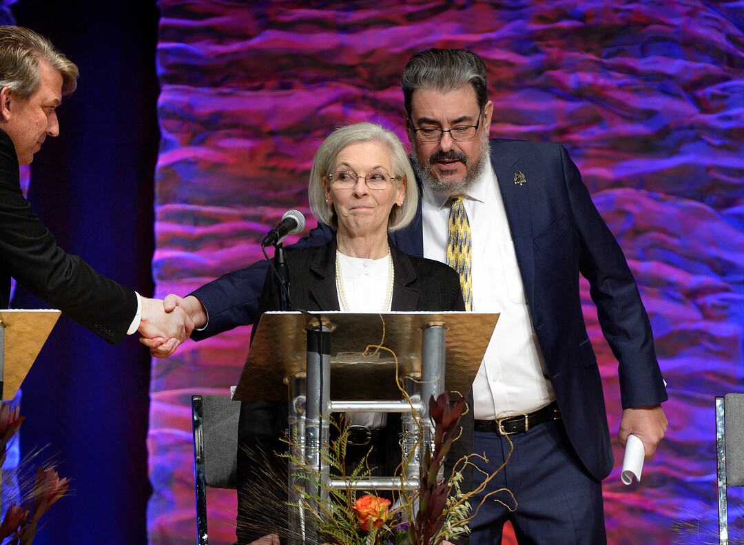 (Scott Sommerdorf   |  The Salt Lake Tribune)   Joe Buchman reaches behind Dr, Kathie Allen to shake hands with his opponent Jim Bennett as Utah's 3rd District Congressional debate began, Friday, October 13, 2017. 