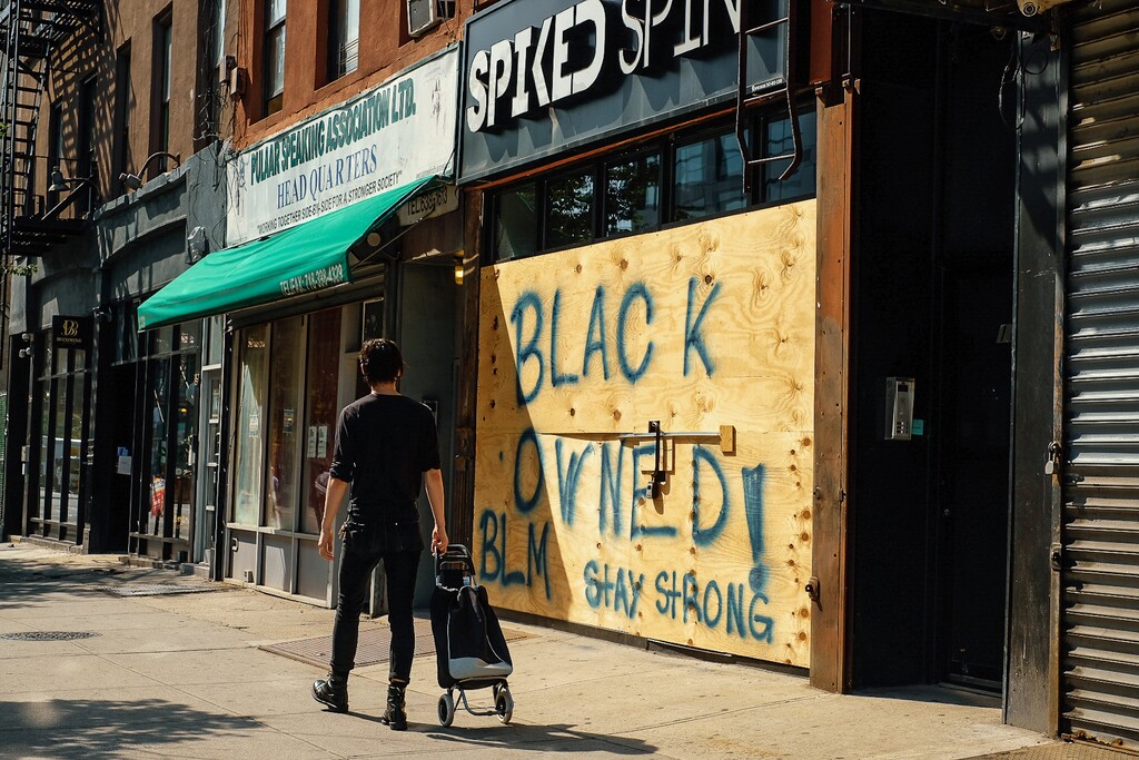 (Laylah Amatullah Barrayn | The New York Times) Spiked Spin, a Black-owned business in Brooklyn, boarded up on June 20, 2020. Black business owners are more likely to be hindered in seeking coronavirus financial aid than their white peers, a new study has found.