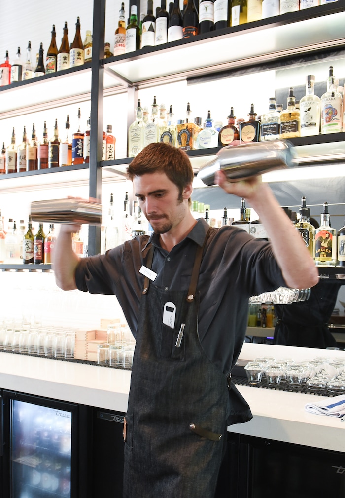 (Francisco Kjolseth  |  The Salt Lake Tribune)  Ethan Conner whips up drinks for patrons at Post Office Place, a new bar by the same owners as Takashi, located next door, on Tuesday, June 19, 2018. One of the main reasons Takashi and Tamara Gibo opened this downtown watering hole is so that their patrons could have a drink while waiting for a seat at Takashi where the wait can sometimes be an hour long and liquor laws don't allow cocktails unless you are seated.