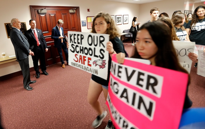 Student survivors from Marjory Stoneman Douglas High School, where moe than a dozen students and faculty were killed in a mass shooting on Wednesday, walk past the house legislative committee rom, to talk to legislators at the state Capitol, regarding gun control legislation, in Tallahassee, Fla., Wednesday, Feb. 21, 2018. (AP Photo/Gerald Herbert)