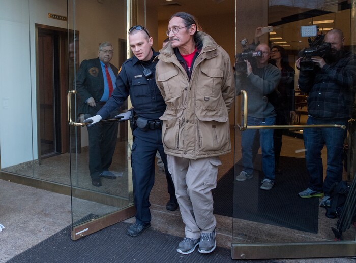 (Rick Egan  |  The Salt Lake Tribune)

Attorney, Robert Sykes (left) watches as his client, Jackie Sanchez is arrested by Salt Lake City police, after they came up to his 2nd floor office to get him, after a media conference in his office about an abuse of force claim against the Salt Lake City Police, that Sanchez was attacked by a police dog on July 28. Wednesday, December 6, 2017.


