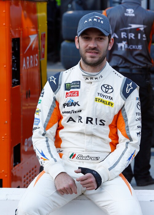 Driver Daniel Suarez sits on pit wall before practice pit road before practice for a NASCAR Cup Series auto race, Saturday, April 14, 2018, in Bristol, Tenn. (AP Photo/Wade Payne)