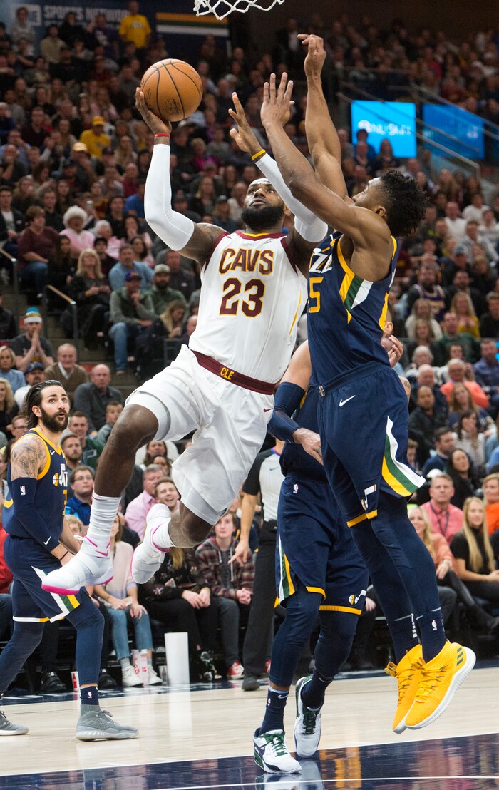 (Rick Egan  |  The Salt Lake Tribune)  Utah Jazz guard Donovan Mitchell (45) is called for a foul as he defends, as Cleveland Cavaliers forward LeBron James (23) takes the ball to the hoop, in NBA action Utah Jazz vs Cleveland Cavaliers, in Salt Lake City,  Saturday, December 30, 2017.


