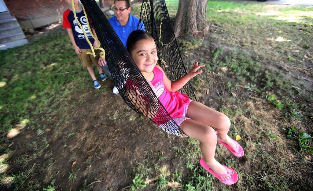 (Rick Bowmer | The Associated Press) Adalene Moreno plays in a swing Wednesday, Aug. 1, 2018, in Sandy, Utah. Adalene, a 4-year-old Utah girl who had two fingers partially amputated in a grocery store escalator last year is learning to color pictures again, but she could be facing more surgeries as her small hands grow. The family filed a lawsuit last week claiming it happened because the Salt Lake City store’s failure to keep the escalator properly maintained left a hole where her fingers got caught.
