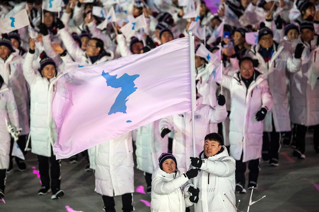 (Chris Detrick  |  The Salt Lake Tribune)  North Korean ice hockey player Hwang Chung Gum and South Korean bobsledder Won Yun-jong wave a Korean unification flag as they lead the Korean delegation during the Pyeongchang 2018 Winter Olympics opening ceremony at Olympic Stadium Friday, February 9, 2018.  