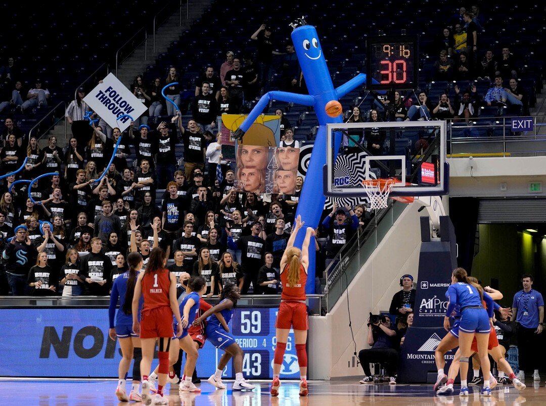 (Francisco Kjolseth | The Salt Lake Tribune) The BYU student section does their best to disrupt a free throw in basketball action between the Utah Utes and the Brigham Young Cougars, at the Marriott Center in Provo, on Saturday, Dec. 10, 2022.