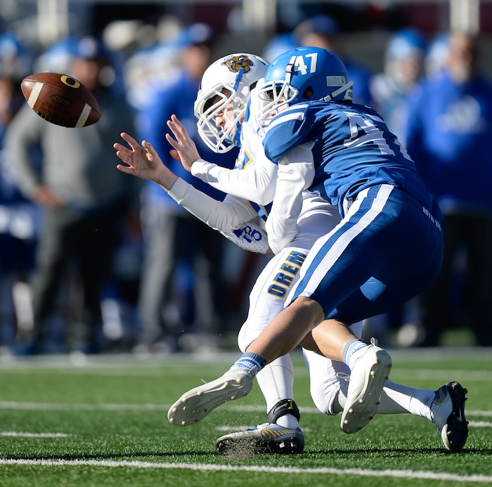 (Francisco Kjolseth  |  The Salt Lake Tribune)  Orem kicker Canyon Esplin tries to get rid of the ball after a bad snap against Dixie's Harrison Beazer in the 4A high school championship game at Rice Eccles Stadium in Salt Lake City, Friday, Nov. 16, 2018.