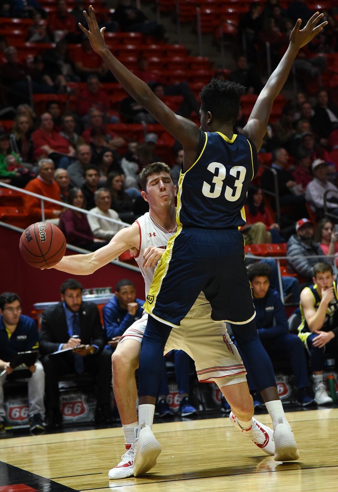 (Francisco Kjolseth  |  The Salt Lake Tribune)  Utah Utes forward Riley Battin (21) throws past Northern Arizona Lumberjacks forward Isaiah Thomas (33) in Men's Basketball at the Jon M Huntsman Center in Salt Lake City, Utah, on Friday, Dec. 21, 2018.