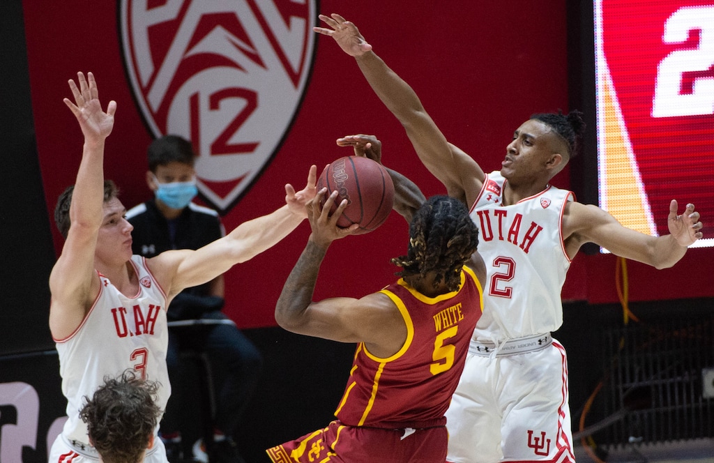 (Francisco Kjolseth  | The Salt Lake Tribune) Utah Utes guard Pelle Larsson (3) and Utah Utes guard Ian Martinez (2) pressure USC Trojans guard Isaiah White (5) in PAC-12 basketball action at the Jon M. Huntsman Center, on Saturday, Feb. 27, 2021.