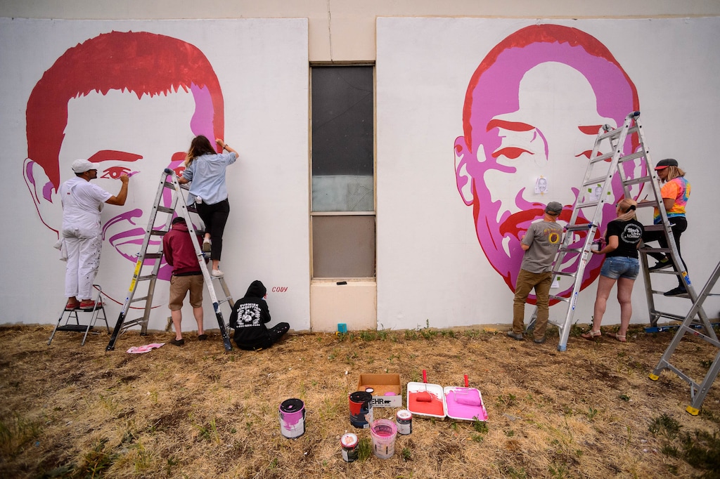 (Trent Nelson  |  The Salt Lake Tribune) Artists add new faces, Cody Belgard and Allen Nelson, to a series of murals depicting victims of police violence at 800 South 300 West in Salt Lake City on Sunday, June 28, 2020.