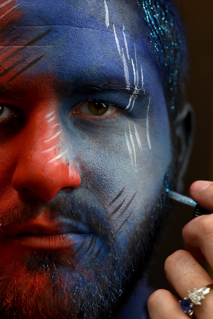 (Francisco Kjolseth | The Salt Lake Tribune) BYU and Utah fan alike Brad Klekas of South Jordan shows his mutual admiration by stepping into the Tribune studio to get both colors in anticipation of the upcoming match up between the two rival teams on Saturday.