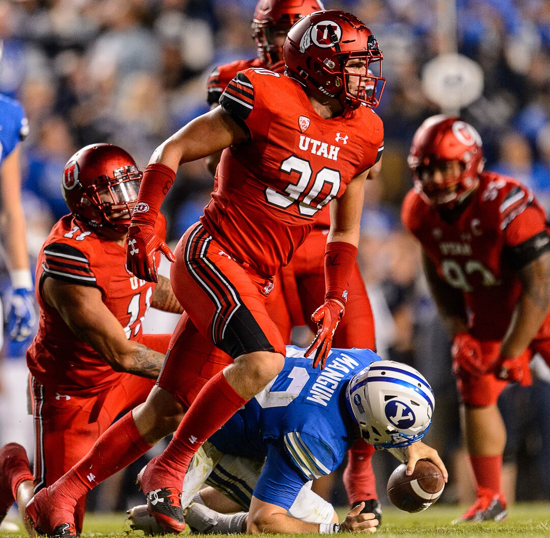 (Trent Nelson | The Salt Lake Tribune)  Utah Utes linebacker Cody Barton (30) sacks Brigham Young Cougars quarterback Tanner Mangum (12) as BYU hosts Utah, NCAA football in Provo, Saturday September 9, 2017.
