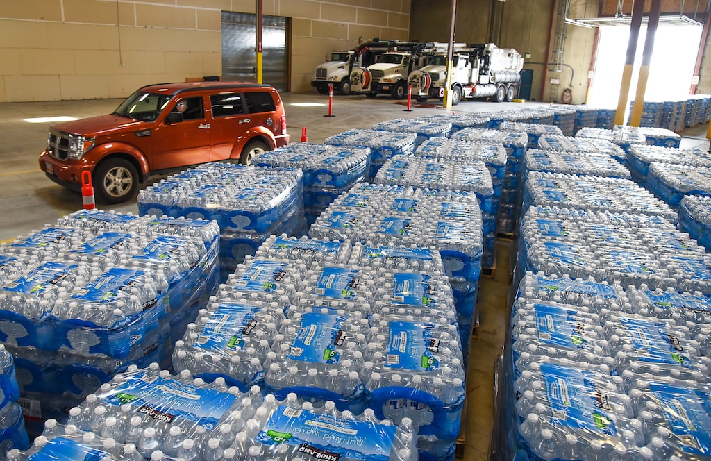 (Francisco Kjolseth  |  Tribune file photo)  Cases of water stored at the Sandy Operations Center at 9150 South, 150 East on Sunday, on Feb. 17, 2019 for residents to drive thru and pick up. The city issued a no drink after a fluoride pump malfunctioned and contaminated its water system.