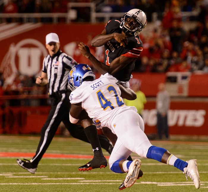 (Trent Nelson | The Salt Lake Tribune) Utah Utes quarterback Tyler Huntley (1) is hit by San Jose State Spartans linebacker Jamal Scott (42) after throwing the ball out of bounds as the Utah Utes host the San Jose State Spartans, NCAA football at Rice-Eccles Stadium in Salt Lake City, Saturday September 16, 2017.