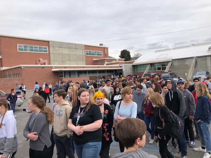 (Chris Detrick  |  The Salt Lake Tribune) Students at Highland High School in Salt Lake City gather on the football field to participate in a nationwide demonstration for better gun safety laws on March 14, 2018.