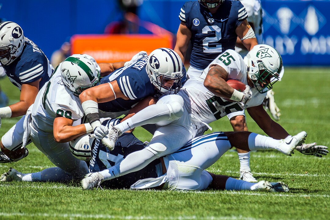 (Chris Detrick  |  The Salt Lake Tribune)  Brigham Young Cougars linebacker Fred Warner (4) and Brigham Young Cougars defensive lineman Corbin Kaufusi (90) tackle Portland State Vikings running back Jason Talley (25) during the game at LaVell Edwards Stadium Saturday, August 26, 2017.