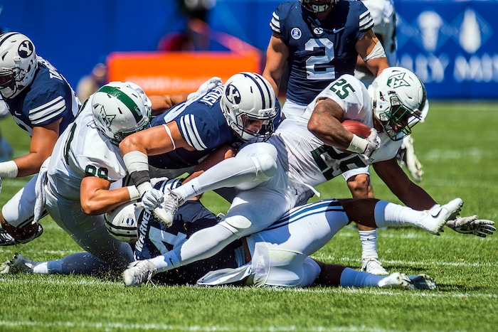 (Chris Detrick  |  The Salt Lake Tribune)  Brigham Young Cougars linebacker Fred Warner (4) and Brigham Young Cougars defensive lineman Corbin Kaufusi (90) tackle Portland State Vikings running back Jason Talley (25) during the game at LaVell Edwards Stadium Saturday, August 26, 2017.