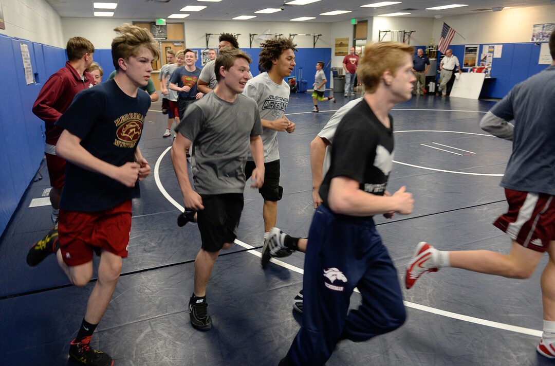(Francisco Kjolseth  |  The Salt Lake Tribune)  Olympic wrestling champion Rulon Gardner runs an introductory clinic with young wrestlers at Herriman High School after being introduced as the new coach on Wed. May 17, 2018, as they get ready with their warm up exercises. 