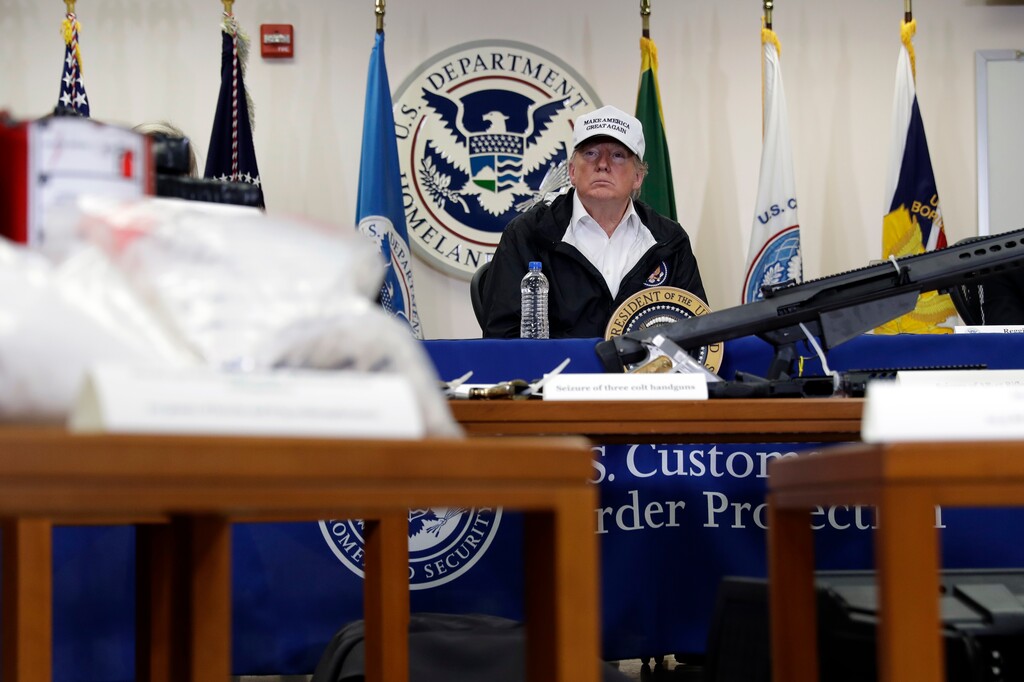 (Evan Vucci | The Associated Press) In this Jan. 10, 2019, file photo, illegal drugs and weapons are displayed in the foreground as President Donald Trump speaks at a roundtable on immigration and border security at the U.S. Border Patrol McAllen Station in McAllen, Texas. In his demands that Congress set aside $5.7 billion for a border wall, President Donald Trump insists a physical barrier would stop heroin entering the U.S. from Mexico. But U.S. statistics, analysts and testimony at the trial of drug kingpin Joaquin "El Chapo" Guzman in New York show that most hard drugs entering the U.S. from Mexico come through land ports of entry staffed by agents, not open sections of the border.